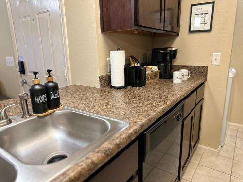 a kitchen with a sink and a counter top at Magnolia Hideaway 1BD-1BA - Gym, Pool, BBQ Grill in Tupelo