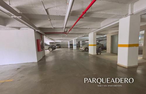 an empty parking garage with cars parked in it at APARTAMENTO VISTA AL MAR WIND 906 in Gaira