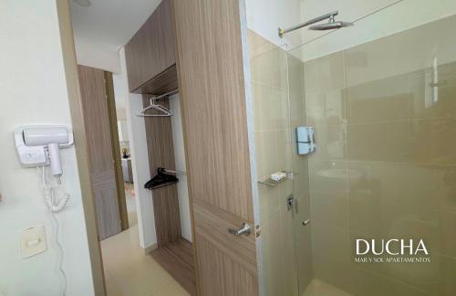 a bathroom with a shower with a glass door at APARTAMENTO VISTA AL MAR WIND 906 in Gaira