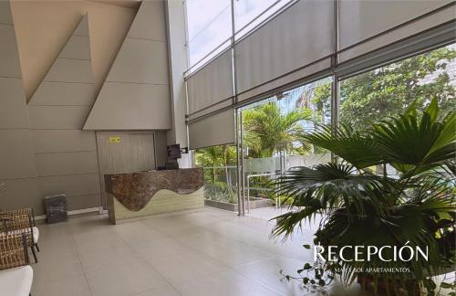 a lobby of a building with a large glass door at APARTAMENTO VISTA AL MAR WIND 906 in Gaira