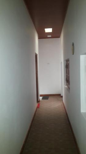 a hallway of an office with white walls and a long room at Mount View Inn in Kandy