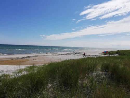 a person standing on a beach with the ocean at Charming Family Retreat - By Traum Ferienwohnungen in Hals