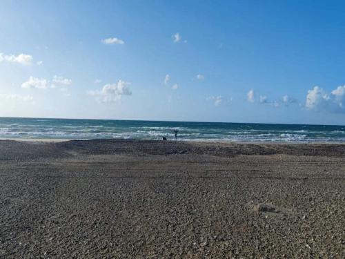 an empty beach with the ocean in the background at 6 person holiday home in Brovst-By Traum in Brovst