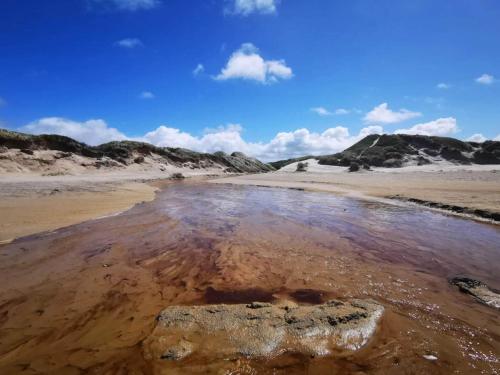 a pool of water in the sand on a beach at 2 person holiday home in Brovst-By Traum in Brovst