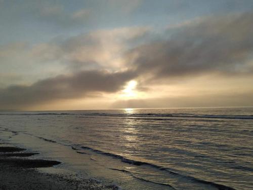 a sunset over the ocean on a beach at 2 person holiday home in Brovst-By Traum in Brovst