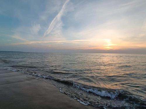 a sunset on the beach with the ocean at 2 person holiday home in Brovst-By Traum in Brovst