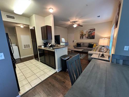 an open living room with a kitchen and a living room at Magnolia Oasis - 2BD-2BA - Gym, Pool, BBQ Grill in Tupelo