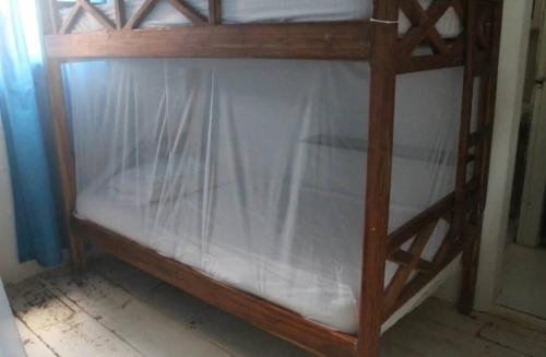 a wooden bunk bed with a glass top with a wooden frame at Taida Hostel Rincón del Mar in Rincón