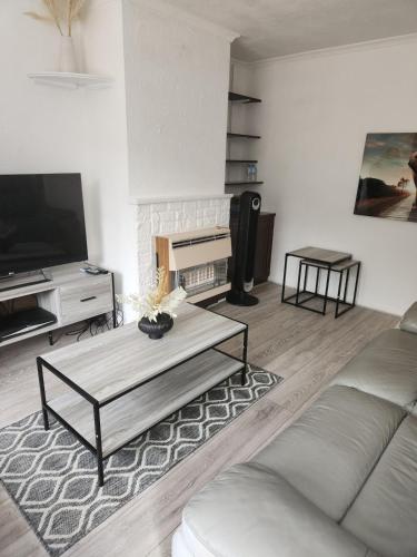 a living room with a couch and a coffee table at Beautiful two Bedroom house Entire house in Stevenage