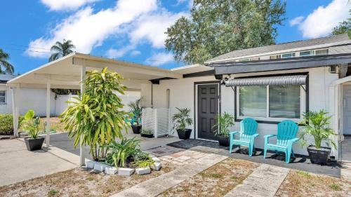 a house with two blue chairs in the front yard at Fall Break Specials! 4 Beds; Great for Lake Myrtle in Auburndale