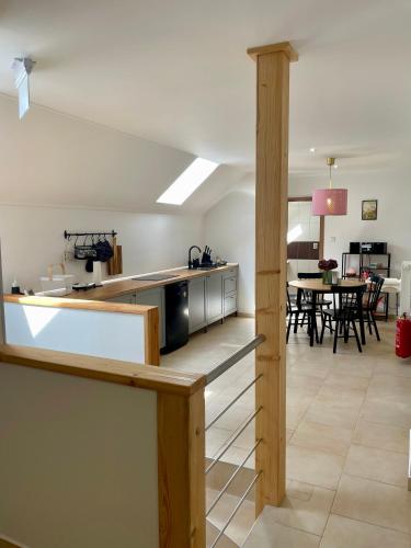 an open kitchen and dining room with a table at Apartmán v Šenku 