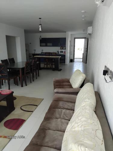 a living room with a couch and a dining room at Fouka bay in Marsa Matruh