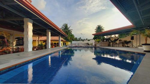 a swimming pool in front of a building at Villa Italia Hotel in Sorsogon