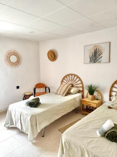a bedroom with two beds and a mirror at Serena Villa in Benicarló
