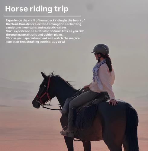 a woman riding a horse in the desert at Sofia Valley Camp in Wadi Rum