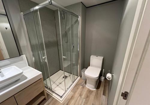 a bathroom with a shower and a toilet and a sink at Cozy Maho Studio w Pool Gym & Nearby Beaches in Maho Reef