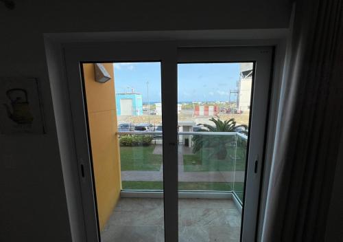 an open door with a view of a city at Cozy Maho Studio w Pool Gym & Nearby Beaches in Maho Reef
