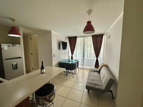 a living room with a couch and a table at Dpto Playa Casino Marina Sol in Coquimbo