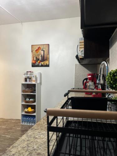 a kitchen with a sink and a counter top at Cozy Comfy Budget Friendly in San Fernando