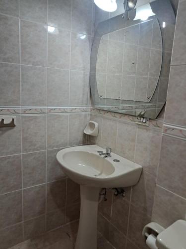 a bathroom with a sink and a mirror at Romantic, Cozy, Fashionable Apt in Quito