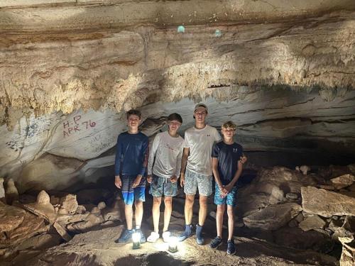 a group of people standing in a cave at Windsong home in South Palmetto Point