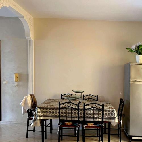 a dining room with a table and two chairs at Spacious Villa with Fireplace for an Unforgettable Stay in El Jadida