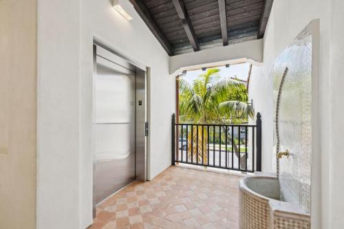 a bathroom with a tub and a door with a balcony at Casa Riviera - Boutique Apartments in Downtown Santa Barbara in Santa Barbara