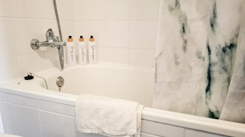 a bathroom with a white tub and a shower at Mãe de Deus - Caniço - Madeira in Caniço