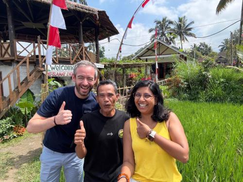 two men and a woman giving thumbs up at Rice Field inn - Lombok in Tetebatu