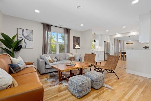 a living room with a couch and a table at Denver 5BR Hot Tub, Pool Table, Ping Pong! in Denver