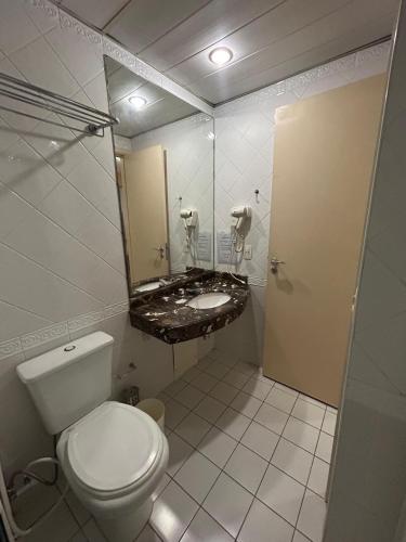 a bathroom with a toilet and a sink at Hotel Mercu Privi Moema Ibirapuera com ar e piscina 1810 in Sao Paulo