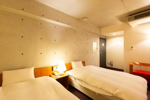 Postel nebo postele na pokoji v ubytování Hotel Landmark Umeda