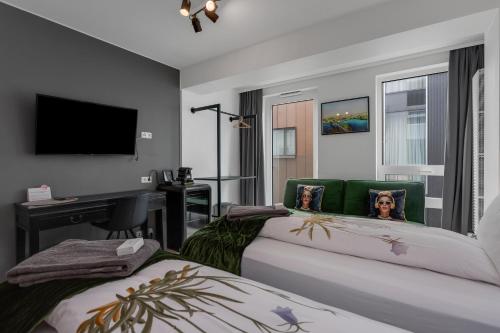 a bedroom with two beds and a flat screen tv at City Center Hotel in Reykjavík