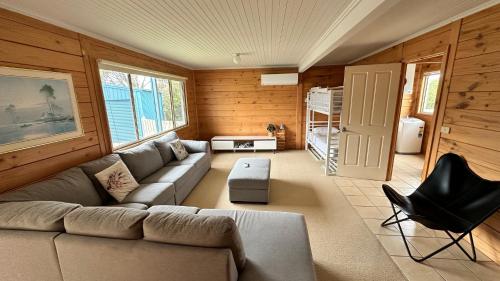 a living room with a couch and a chair at Dolphin in Apollo Bay