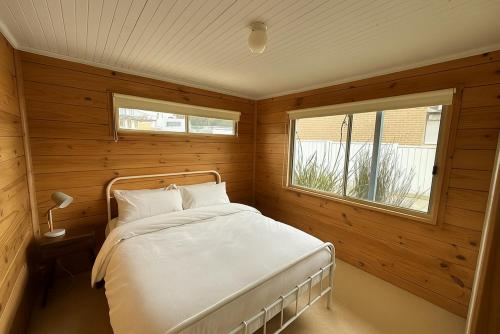a bedroom with a bed and a window in it at Dolphin in Apollo Bay