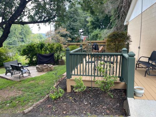 a green fence on a yard with a patio at Mountain Aire Cottages, Inn, & Glamping in Clayton