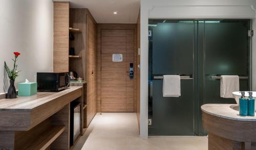 a bathroom with a shower and a sink at Fusion Suites Phuket Patong in Patong Beach