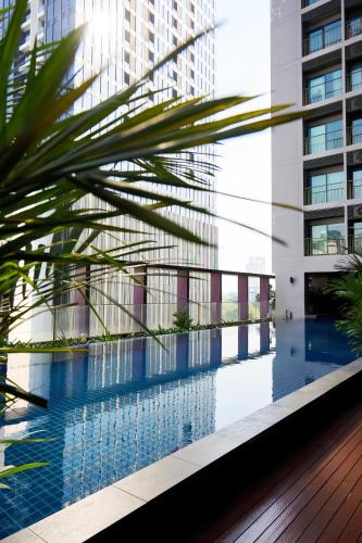 a view of a swimming pool in a building at Noble Remix Bangkok in Bangkok
