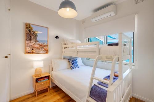 a bedroom with a bunk bed and a bunk bed at Glenelg Beach House With Private Beachfront Pool in Glenelg