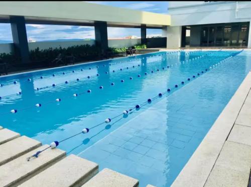 a large swimming pool with blue water at Davao Condo - Avida Towers CM Recto in Davao City