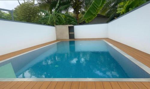 a swimming pool in the middle of a house at Luvi’s Villa in Galle