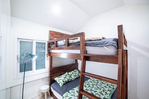 a bunk bed room with two bunk beds in a room at Hamdeok Poolvilla Pension Lamborghini in Jeju