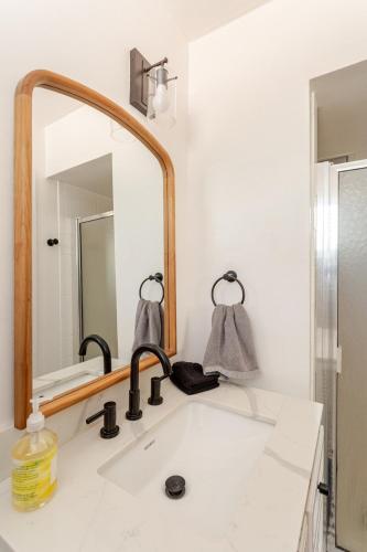 a bathroom with a sink and a mirror at Cheerful Three Bedroom with a Fireplace in Redding