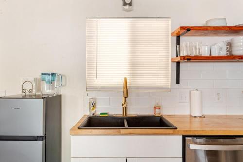 a kitchen with a sink and a refrigerator at Cheerful Three Bedroom with a Fireplace in Redding