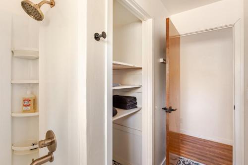a bathroom with a door open to a closet at Cheerful Three Bedroom with a Fireplace in Redding