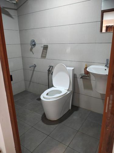 a bathroom with a toilet and a sink at Good land , blue mist resorts in Munnar