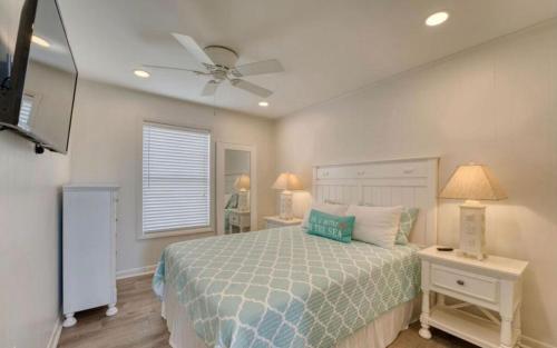 a bedroom with a bed and a ceiling fan at JDH Beachfront Retreat in Ocean City
