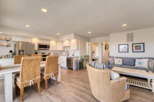 a kitchen and living room with a table and chairs at JDH Beachfront Retreat in Ocean City