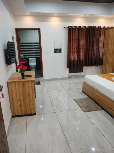 a bedroom with a bed and a bathroom at Good land , blue mist resorts in Munnar