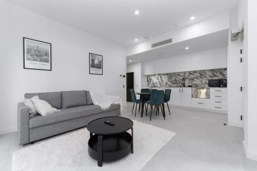 a living room with a couch and a table at Mangini Apartments - Unit 1 in Perth